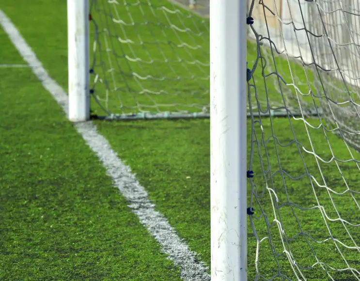 White painted five-a-side football goals to be fixed to the ground with sockets.