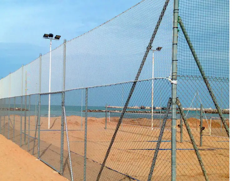 White tennis courts fencing net and beach tennis nets